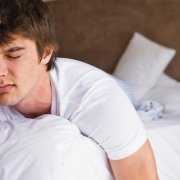 Young man suffering from mold allergies Young man in bed feeling sick