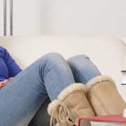 Happy young teenage female using a smartphone at home. Girl talking on a moldy cell phone case