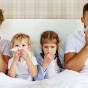 Mold sick family with runny nose and fever in bed Family sick from mold